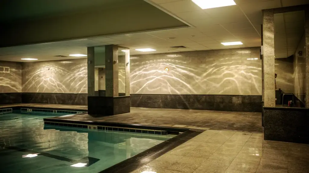 The empty tiled pool hall with light rippling across the wall